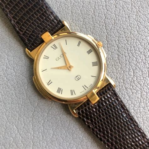 gucci watch 18k gold|Gucci watch gold detailing.